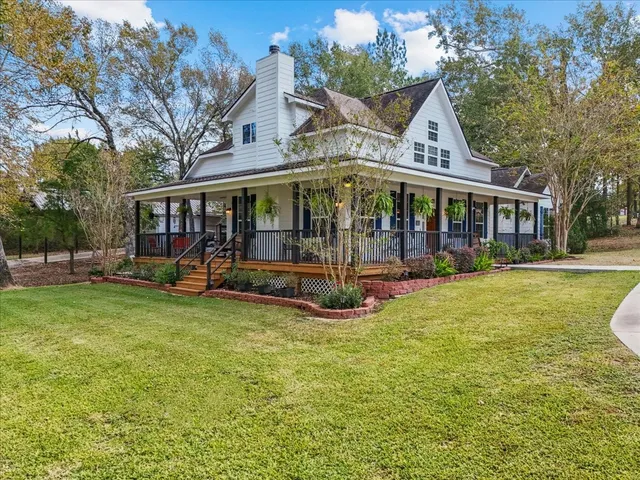 a view of a house with a yard patio and a garden