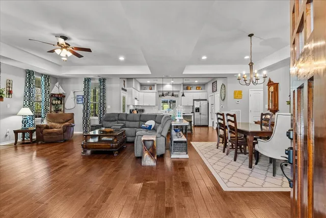 a living room with lots of furniture and kitchen view