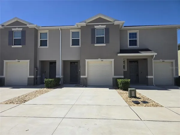 a front view of a house with yard