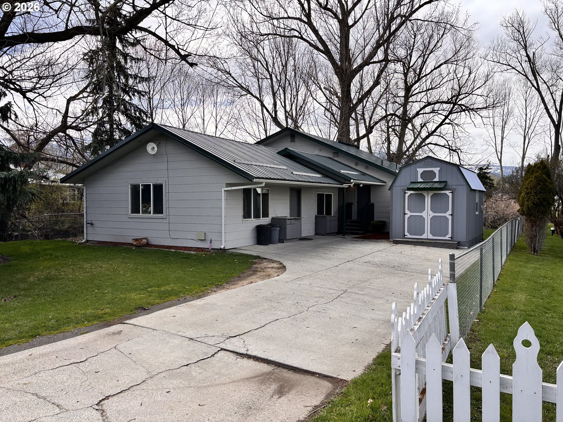 302 Southwest Depot Street Enterprise, OR 97828 - Photo 1 of 22 a front view of a house with a garden and porch