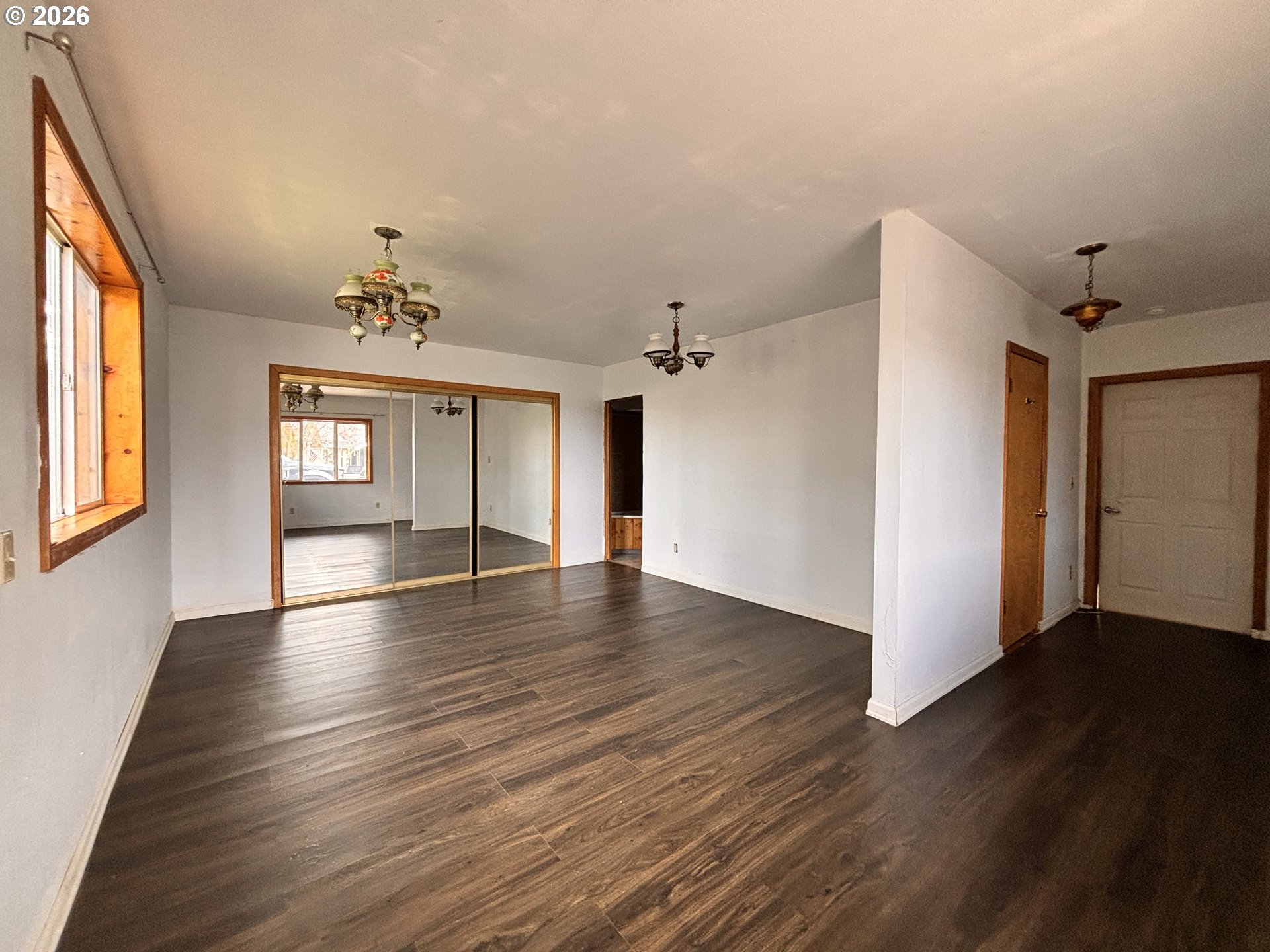 302 Southwest Depot Street Enterprise, OR 97828 - Photo 16 of 22 an empty room with wooden floor and windows
