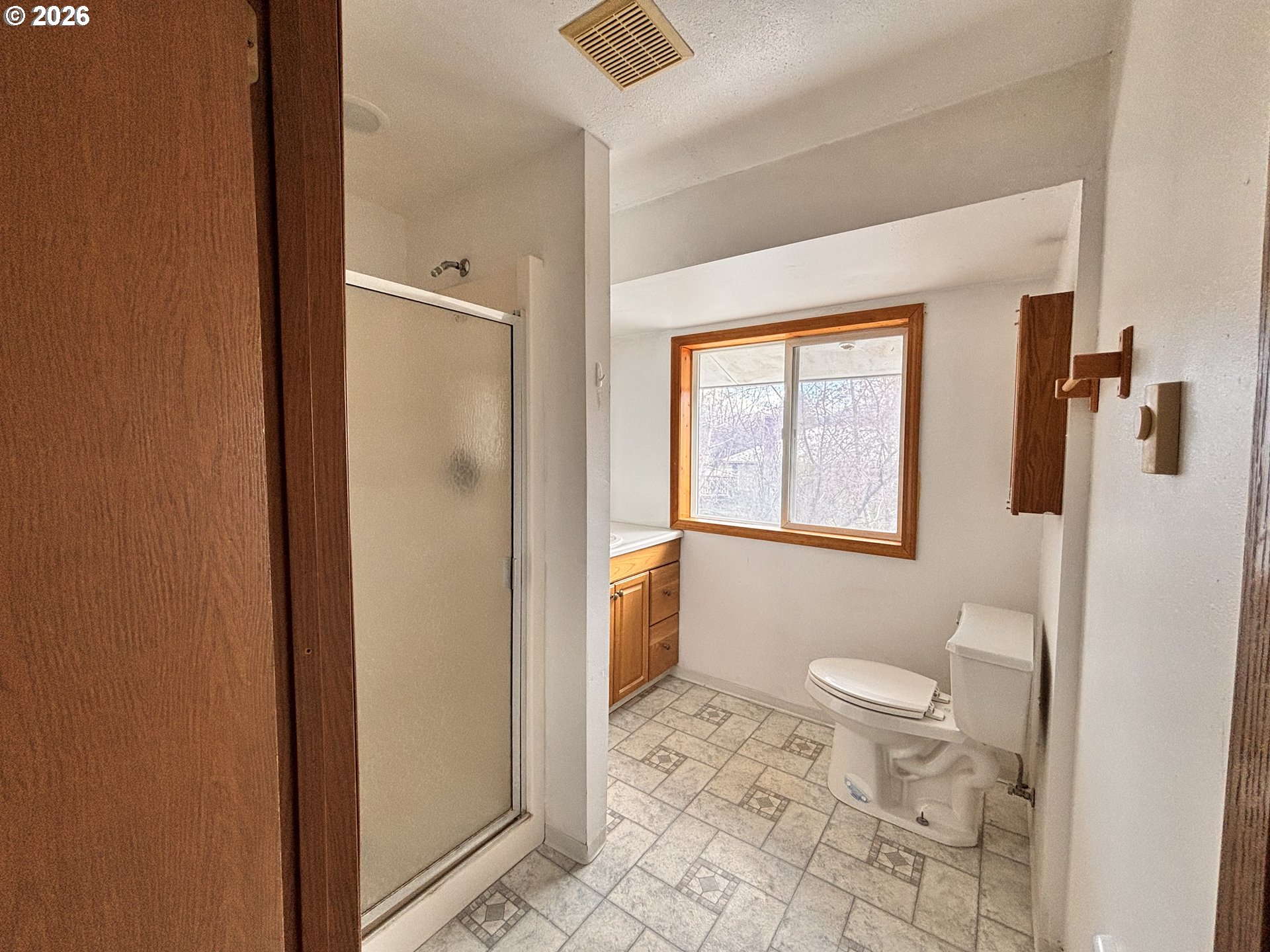 302 Southwest Depot Street Enterprise, OR 97828 - Photo 7 of 22 a bathroom with a granite countertop sink a toilet and shower