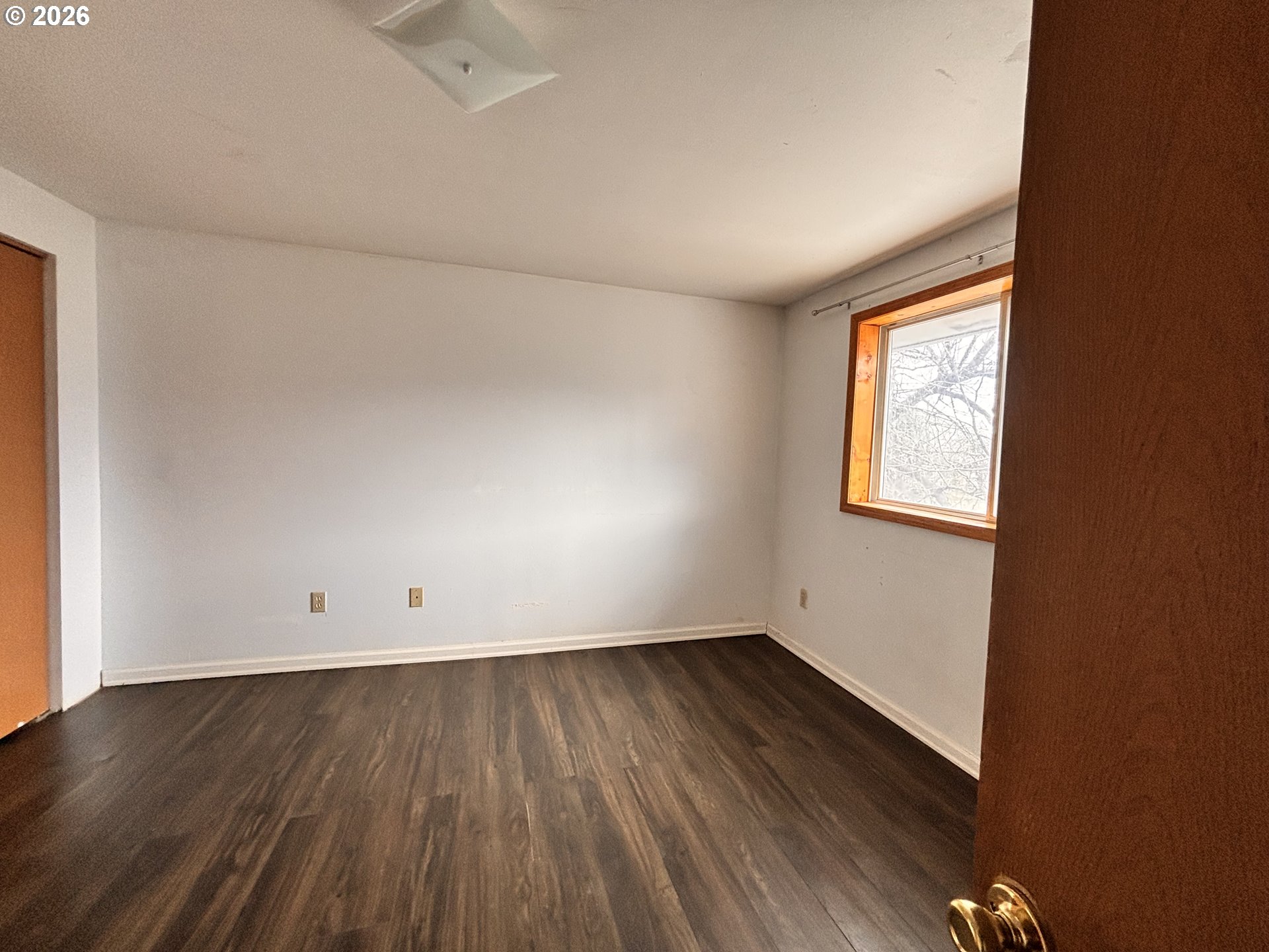 302 Southwest Depot Street Enterprise, OR 97828 - Photo 9 of 22 an empty room with wooden floor and windows