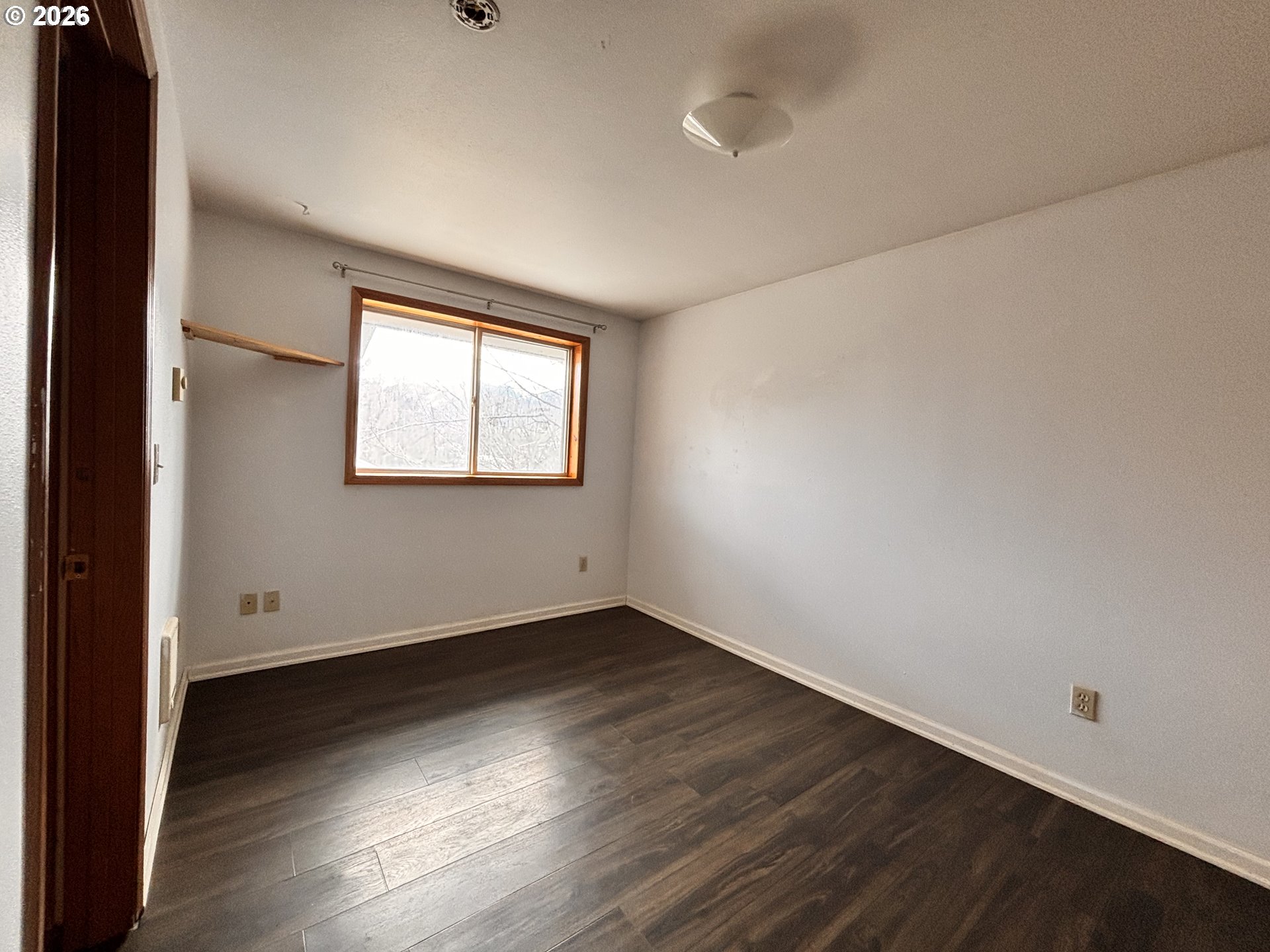 302 Southwest Depot Street Enterprise, OR 97828 - Photo 10 of 22 an empty room with wooden floor and windows