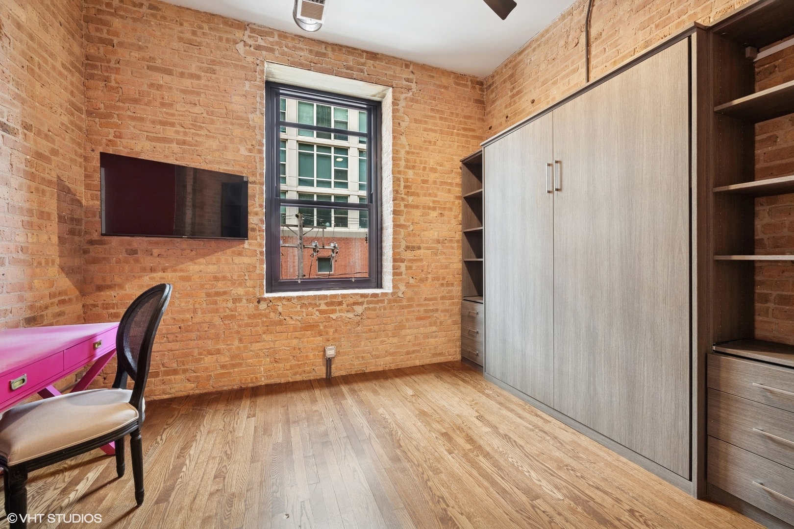 14 North Peoria Street, Unit 3E Chicago, IL 60607 - Photo 23 of 27 a room that has a chair and a flat screen tv