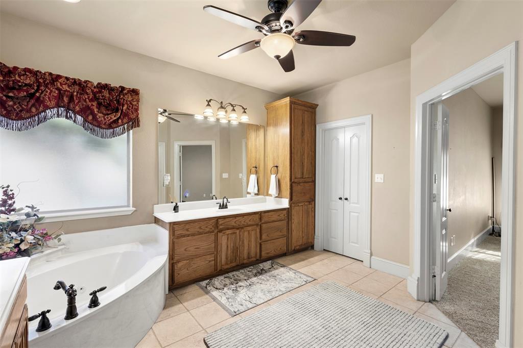 105 Country Ridge Court Red Oak, TX 75154 - Photo 23 of 40 a spacious bathroom with a tub sink shower and mirror