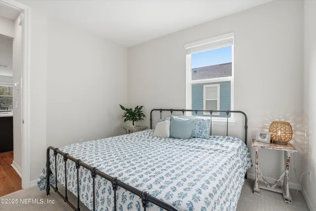 a bedroom with a bed and window