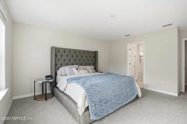 a bedroom with a bed and a night stand