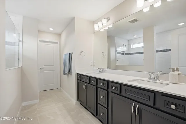 a bathroom with a double vanity sink and a mirror
