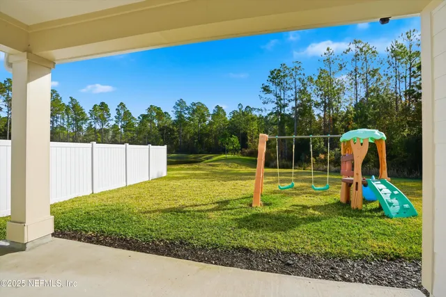 a view of a backyard with a swimming pool