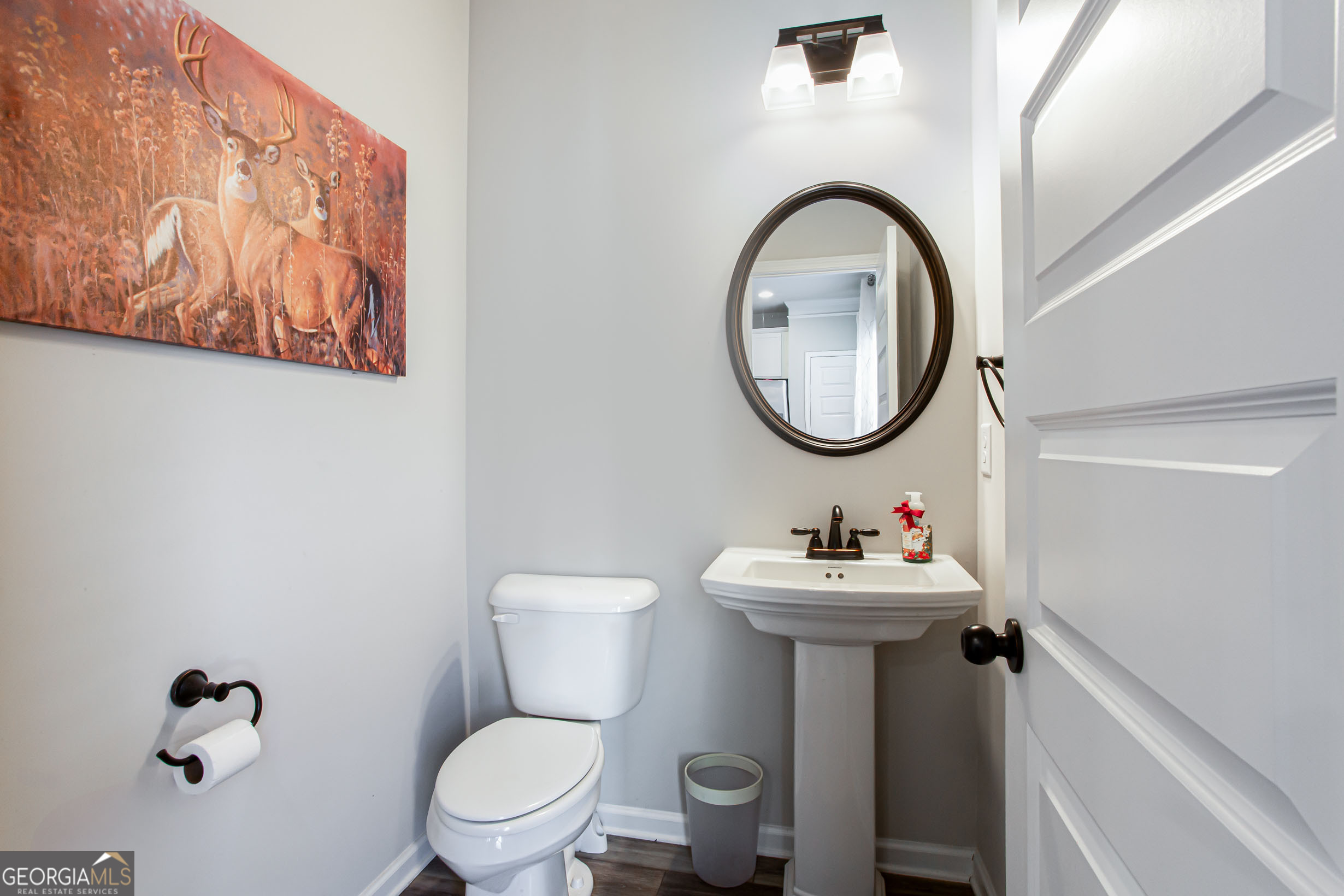 95 Bromes Street Lawrenceville, GA 30046 - Photo 14 of 37 a bathroom with a sink mirror and toilet