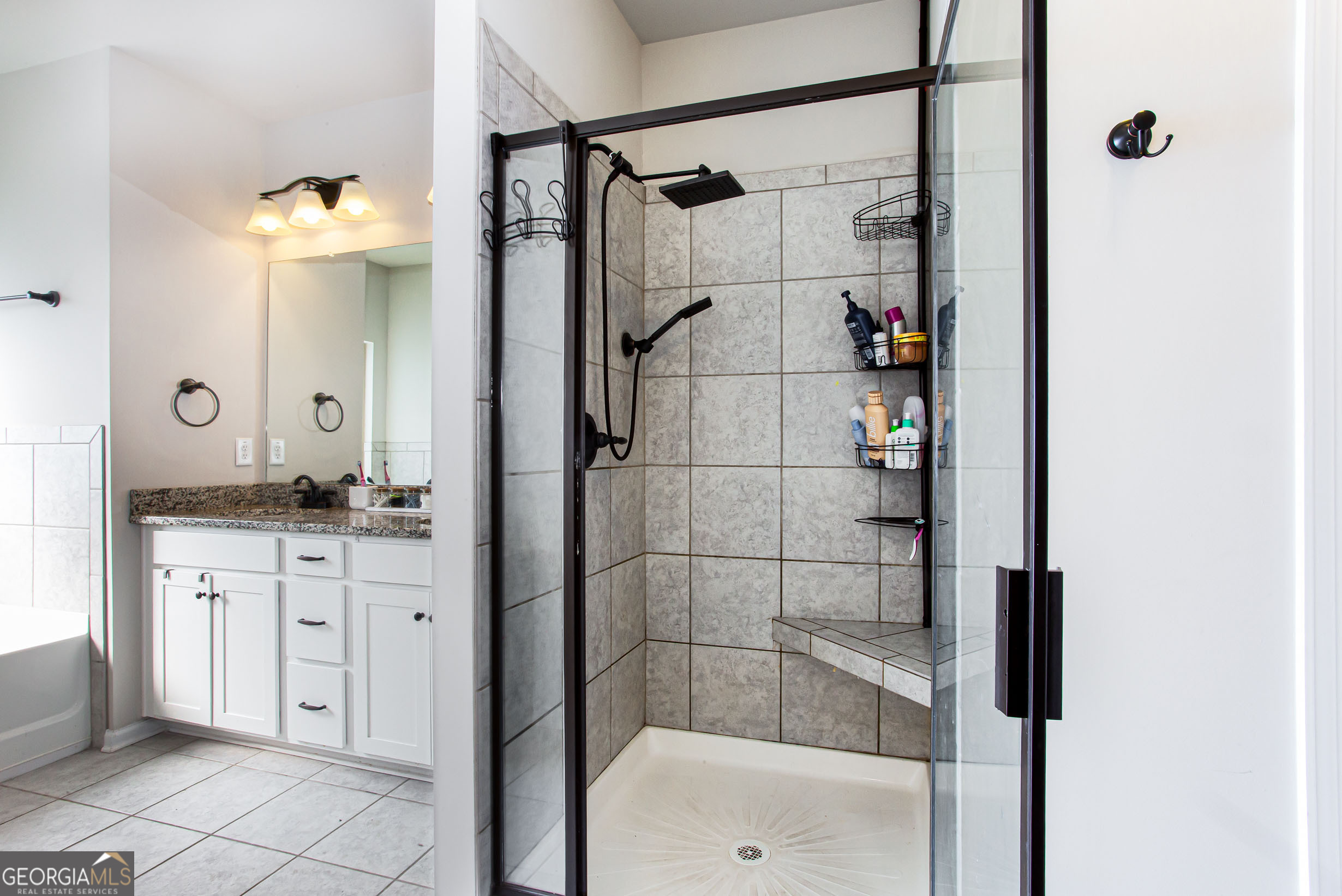 95 Bromes Street Lawrenceville, GA 30046 - Photo 19 of 37 a bathroom with a shower sink and mirror