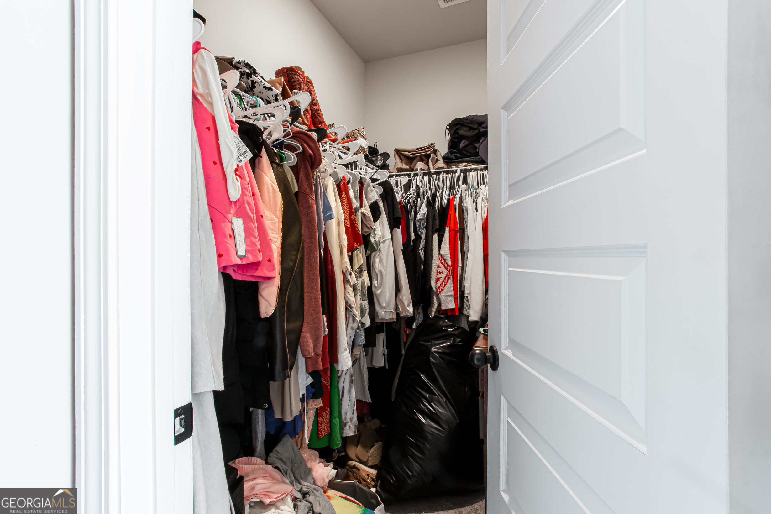 95 Bromes Street Lawrenceville, GA 30046 - Photo 22 of 37 a view of walk in closet with clothes