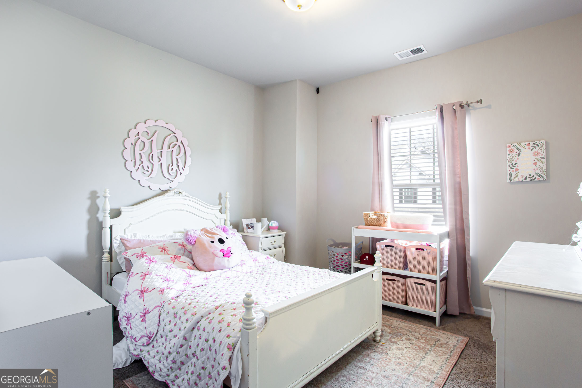 95 Bromes Street Lawrenceville, GA 30046 - Photo 24 of 37 a bedroom with a bed and a chandelier