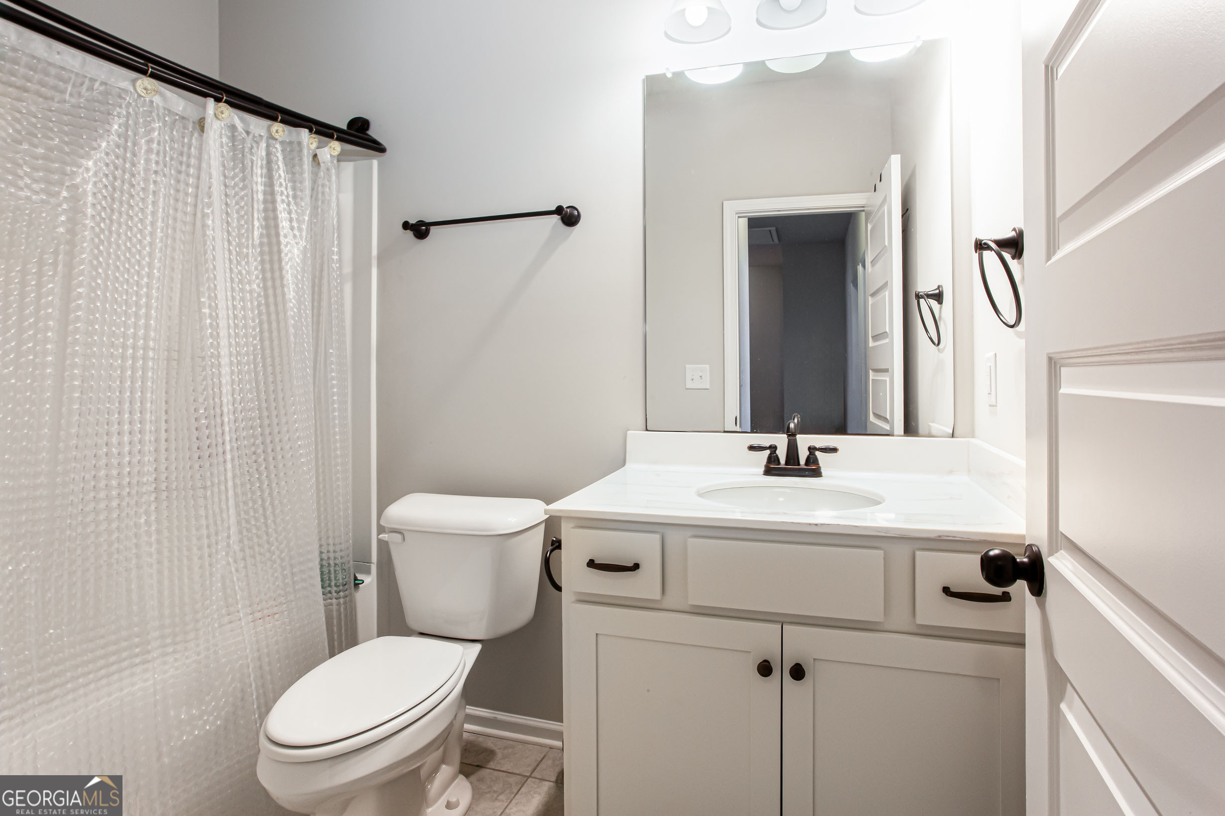 95 Bromes Street Lawrenceville, GA 30046 - Photo 26 of 37 a bathroom with a sink a toilet and shower