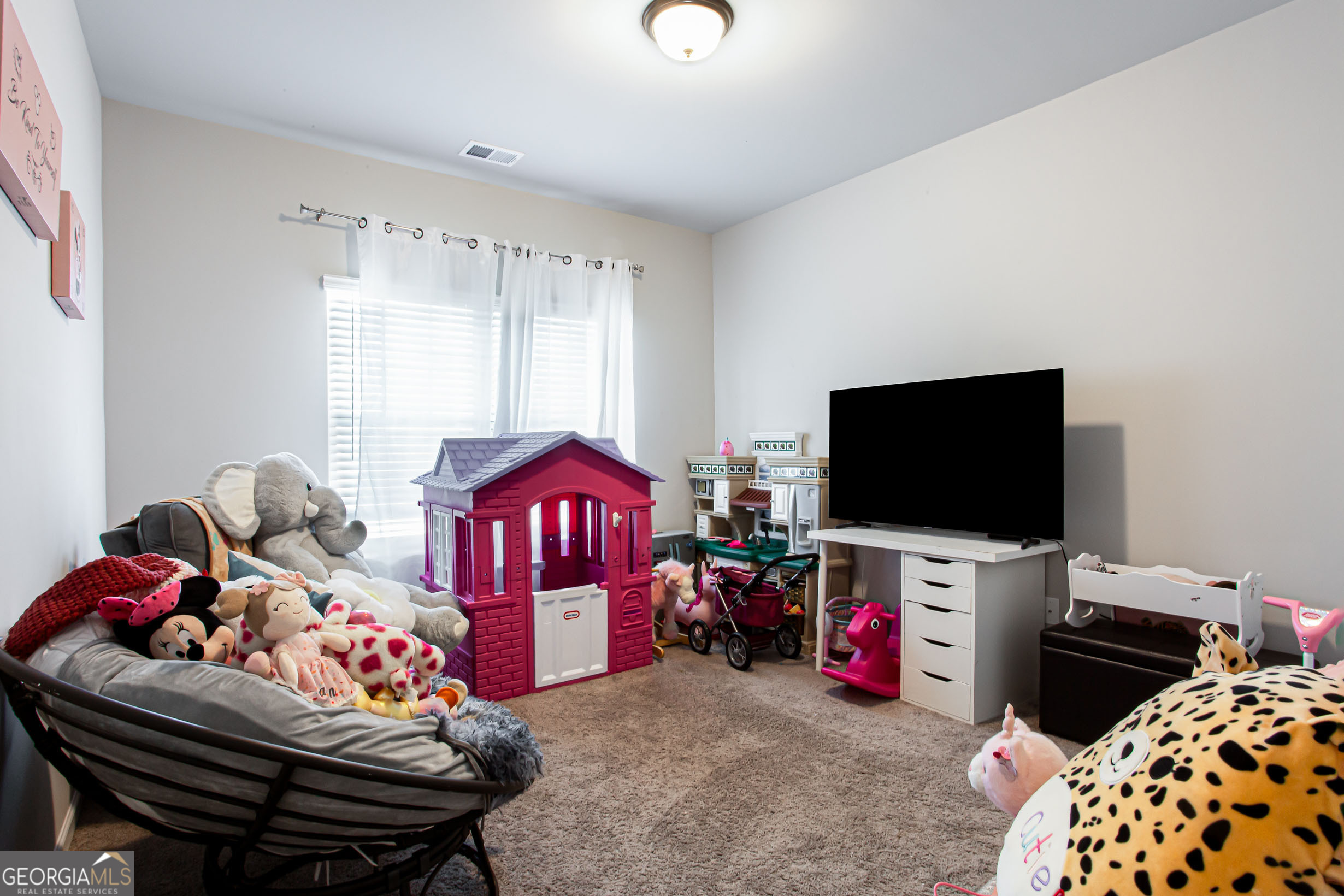 95 Bromes Street Lawrenceville, GA 30046 - Photo 28 of 37 a bedroom with furniture and a flat screen tv