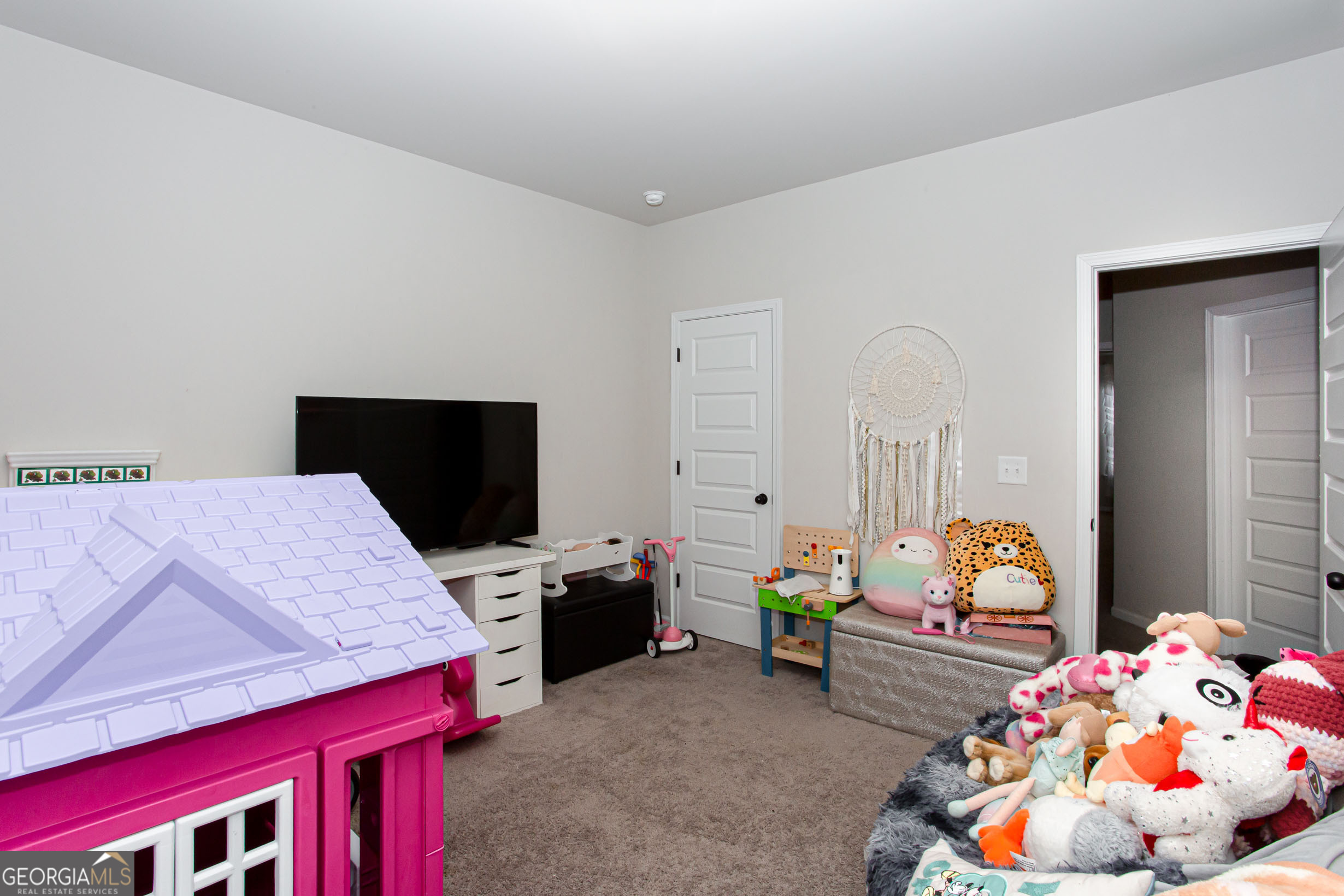 95 Bromes Street Lawrenceville, GA 30046 - Photo 29 of 37 a bedroom with furniture and flat screen tv