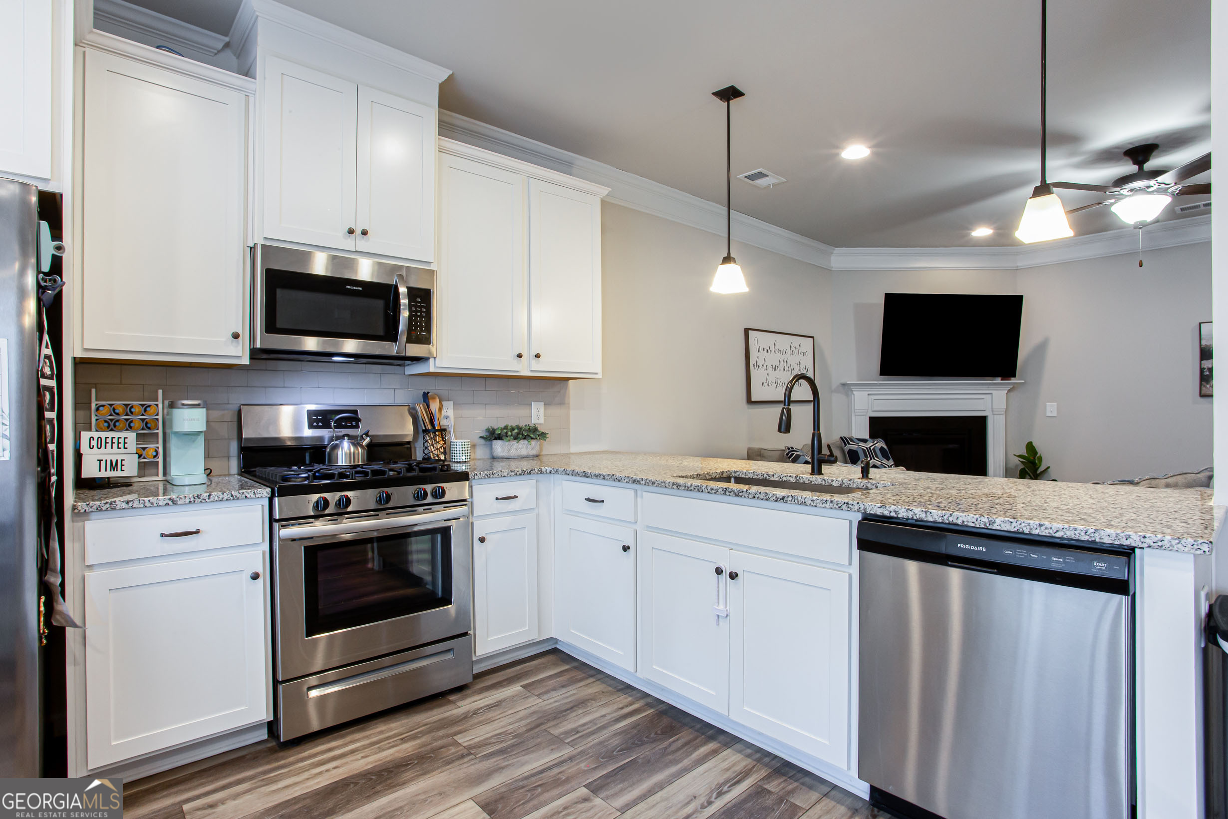 95 Bromes Street Lawrenceville, GA 30046 - Photo 6 of 37 a kitchen with stainless steel appliances granite countertop a stove and a sink