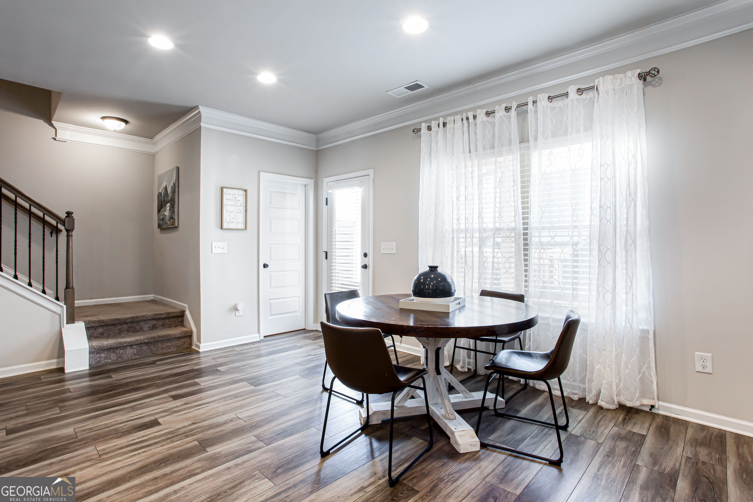 95 Bromes Street Lawrenceville, GA 30046 - Photo 8 of 37 a view of a dining room with furniture and wooden floor