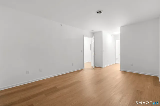 a view of an empty room and wooden floor