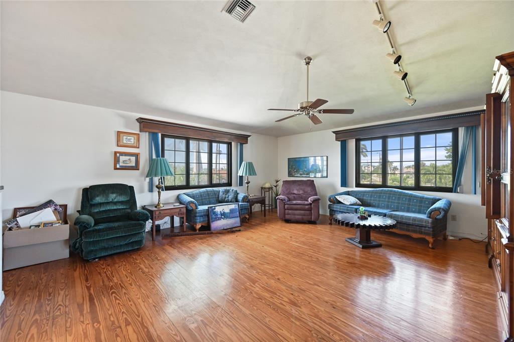 103 Tahiti Circle Naples, FL 34113 - Photo 7 of 37 a living room with furniture window and wooden floor