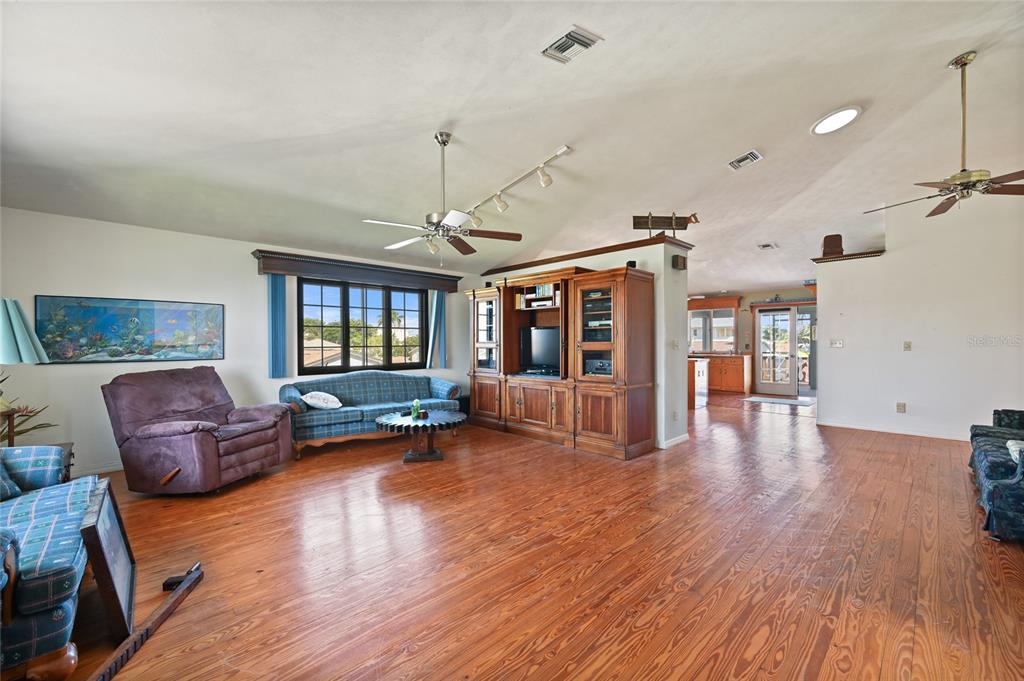 103 Tahiti Circle Naples, FL 34113 - Photo 9 of 37 a living room with furniture and wooden floor