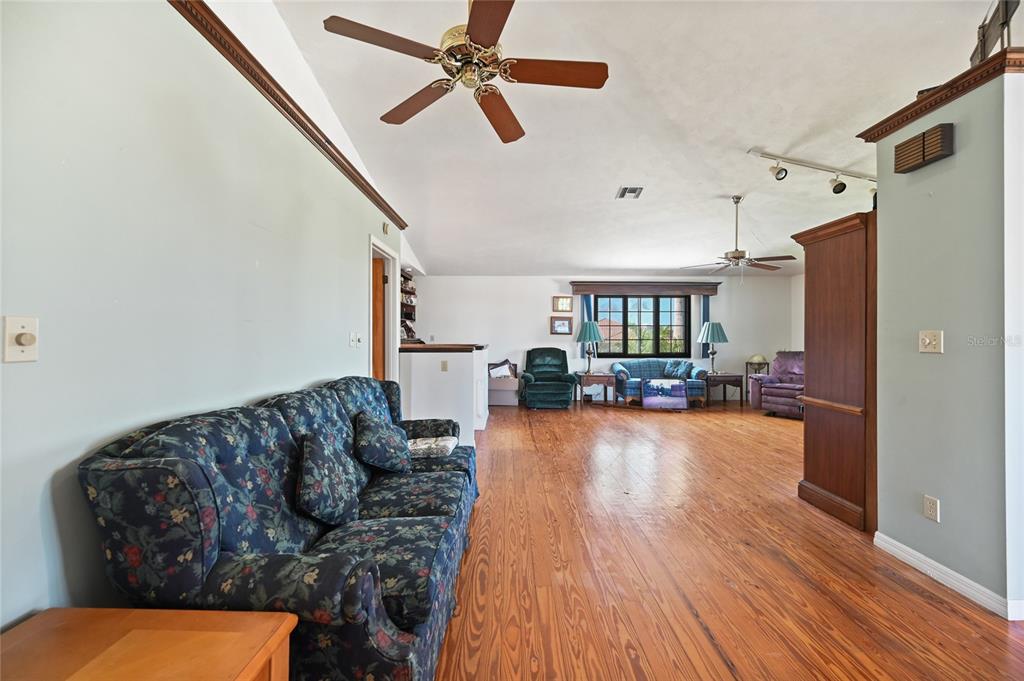 103 Tahiti Circle Naples, FL 34113 - Photo 10 of 37 a living room with furniture and a wooden floor