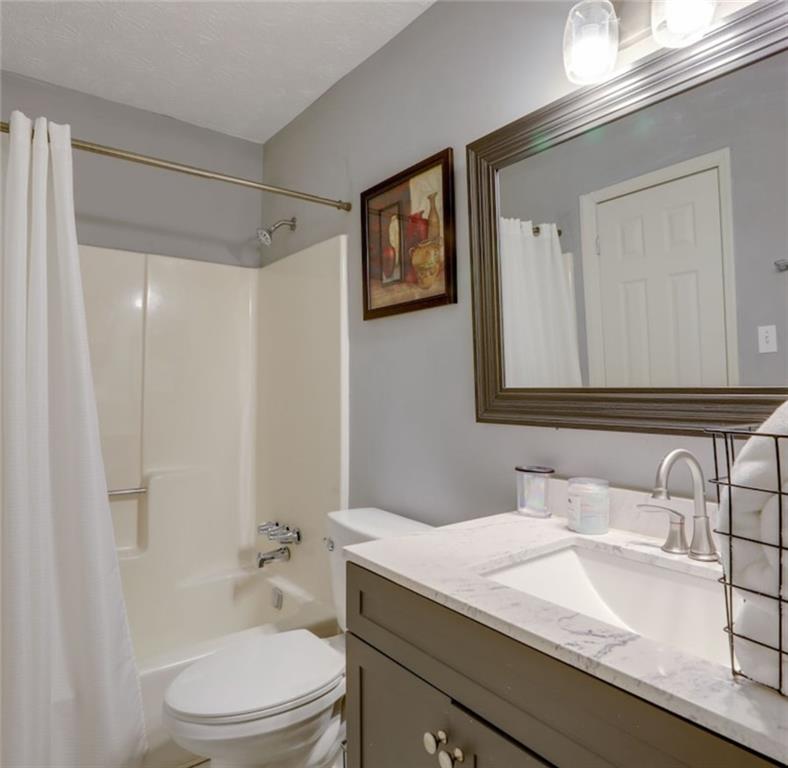 3468 Deer Trace Lithonia, GA 30038 - Photo 12 of 18 a bathroom with a granite countertop sink toilet a large mirror and shower