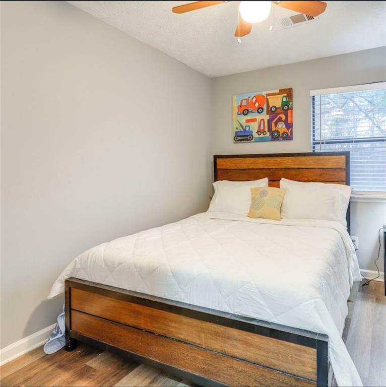 3468 Deer Trace Lithonia, GA 30038 - Photo 15 of 18 a bedroom with a bed and painting on the wall