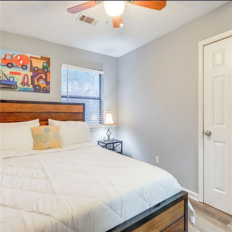 3468 Deer Trace Lithonia, GA 30038 - Photo 16 of 18 a bedroom with a bed and wall painting