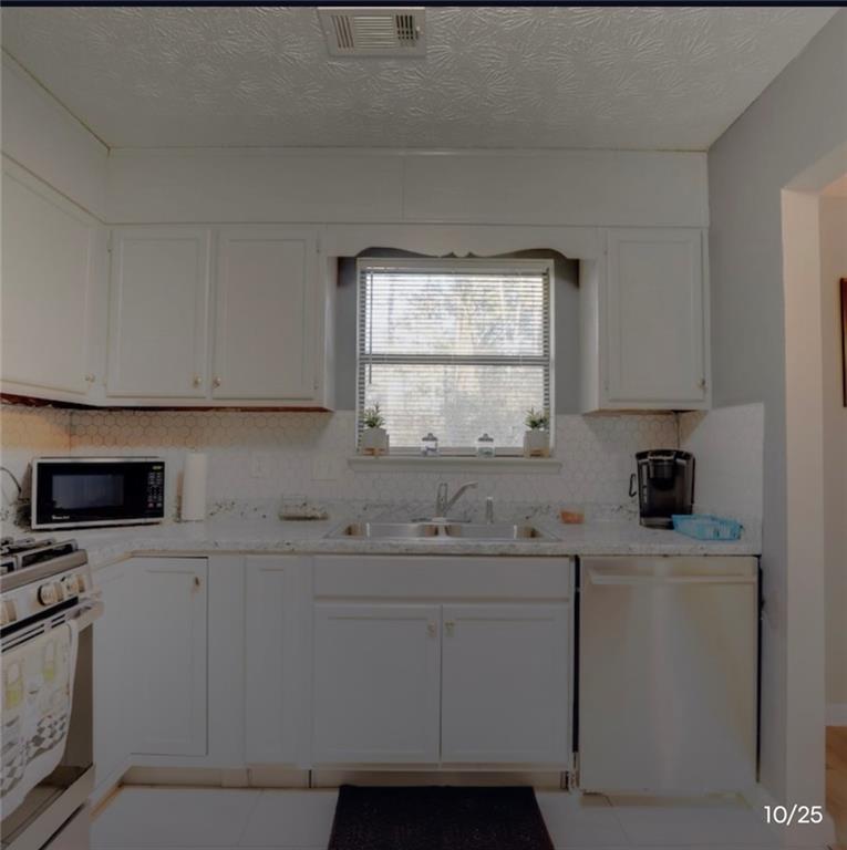 3468 Deer Trace Lithonia, GA 30038 - Photo 5 of 18 a kitchen with stainless steel appliances white cabinets and a sink