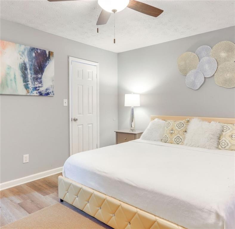 3468 Deer Trace Lithonia, GA 30038 - Photo 10 of 18 a bedroom with a large bed and a chandelier