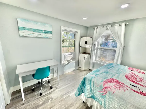 a bedroom with a bed a table and chair