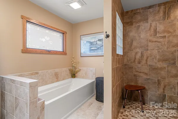 a bathroom with a bathtub and shower