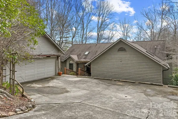 a view of a house with a yard and garage