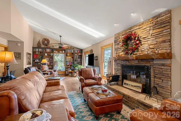 a living room with furniture a fireplace and a flat screen tv