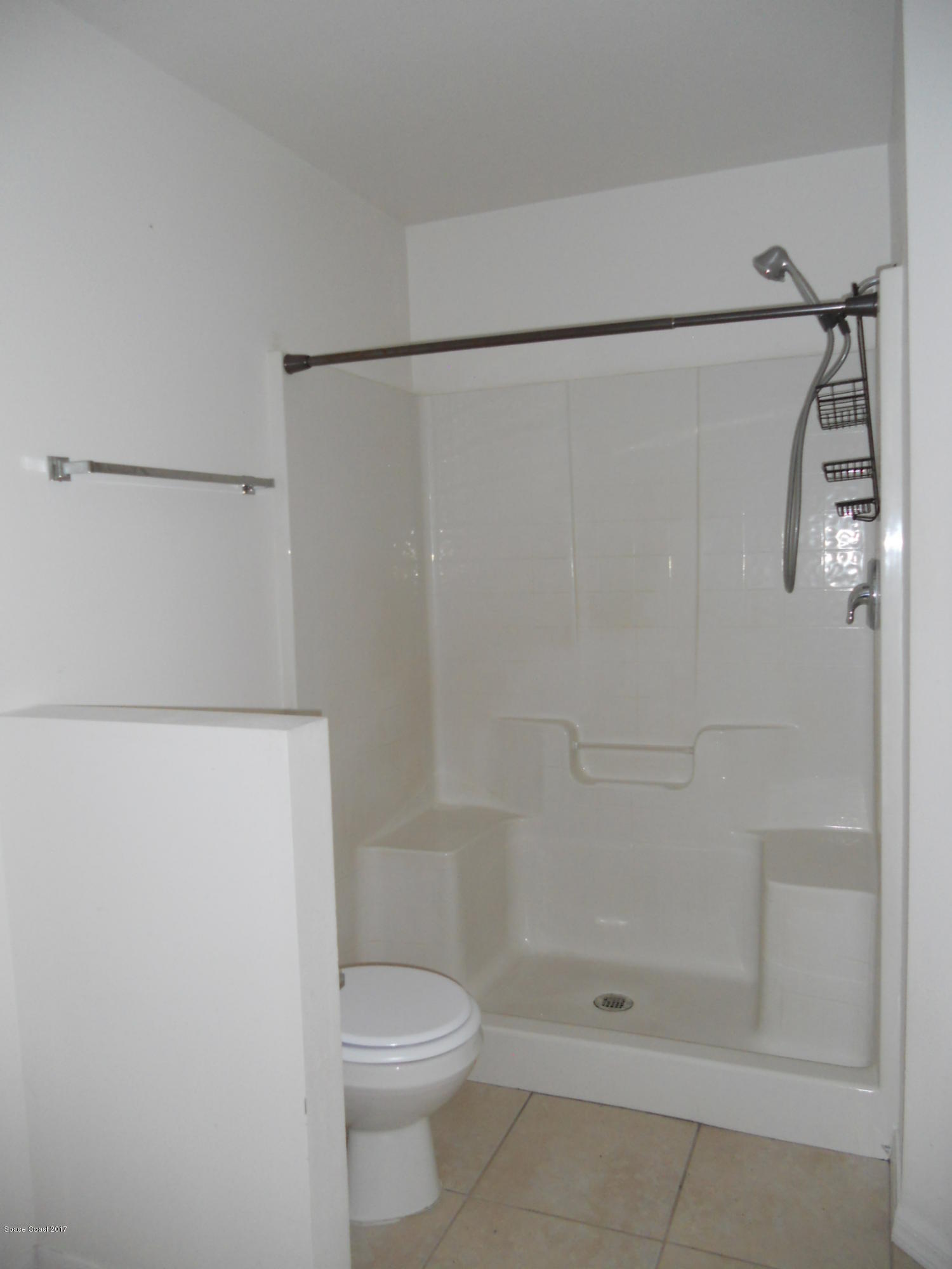 540 Benton Drive Melbourne, FL 32901 - Photo 13 of 14 a bathroom with a shower and a toilet