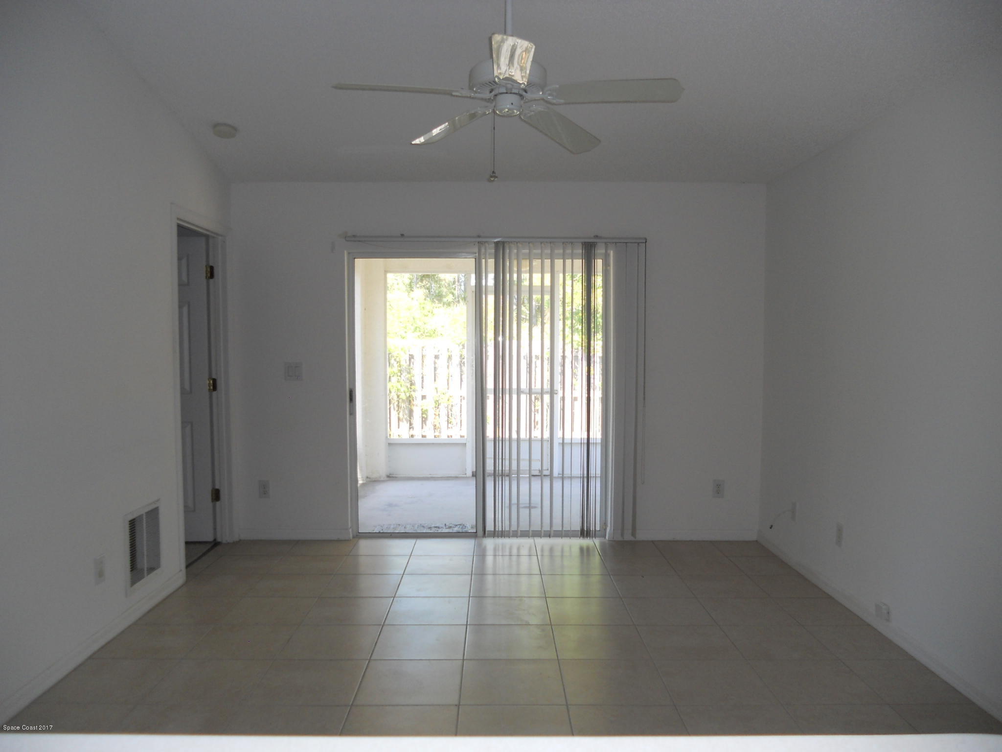 540 Benton Drive Melbourne, FL 32901 - Photo 4 of 14 an empty room with chandelier fan and windows