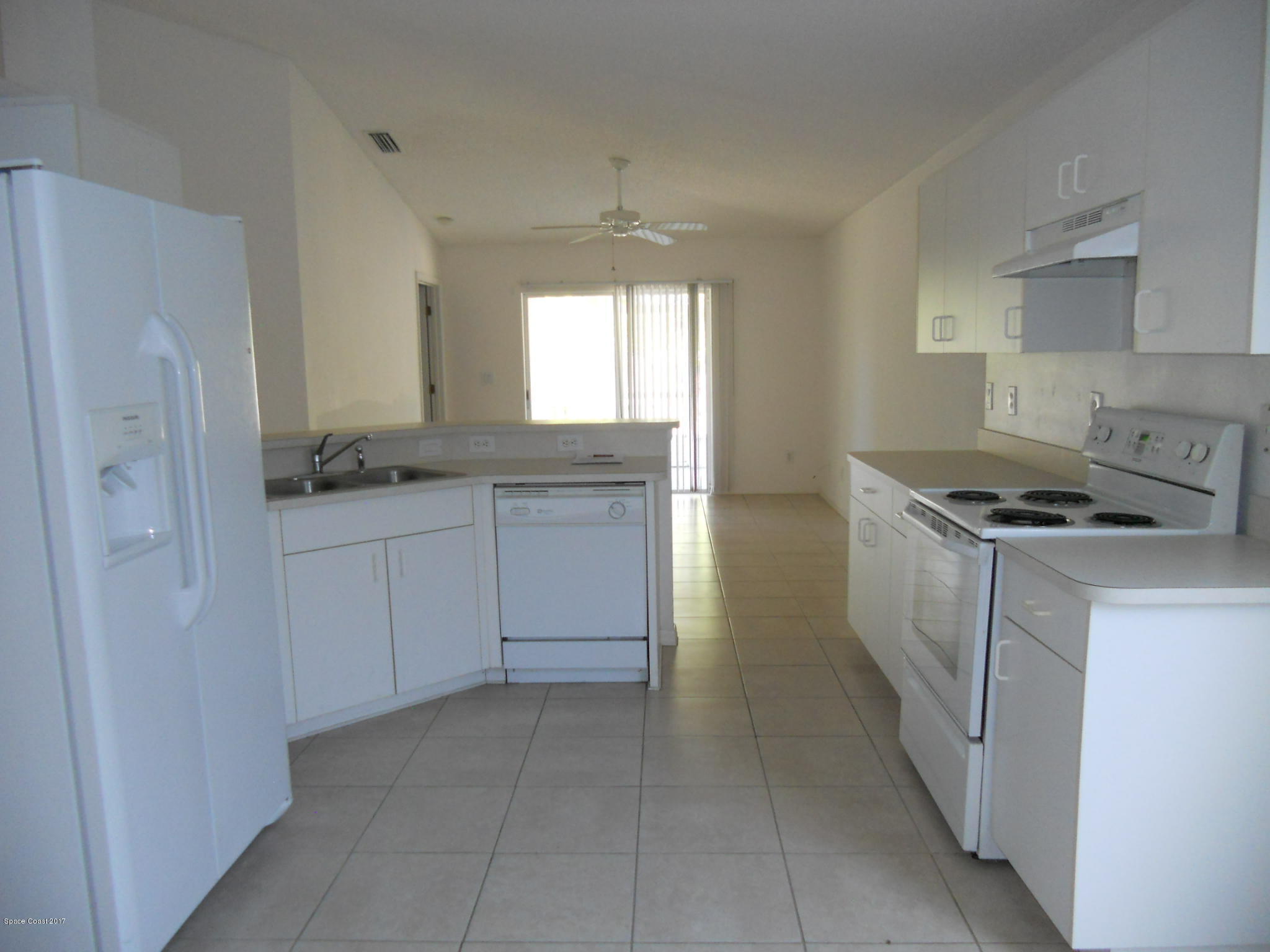 540 Benton Drive Melbourne, FL 32901 - Photo 6 of 14 a kitchen with a sink stove and refrigerator