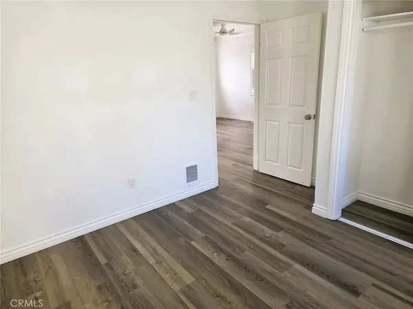 an empty room with wooden floor