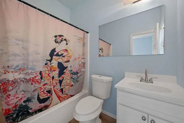 a white toilet sitting next to a bathroom sink