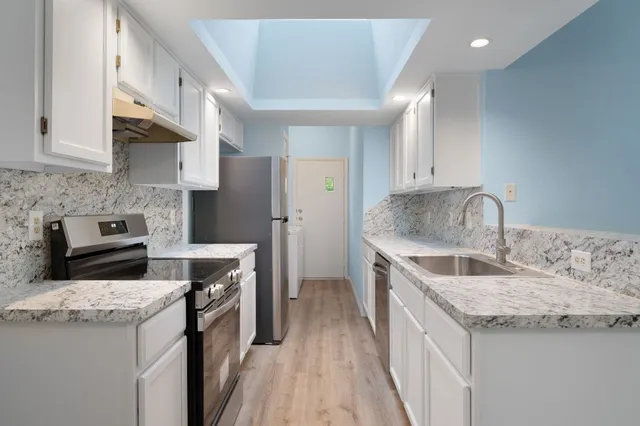 a kitchen with a sink stove and refrigerator