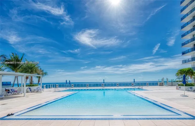 a view of a swimming pool with an outdoor seating