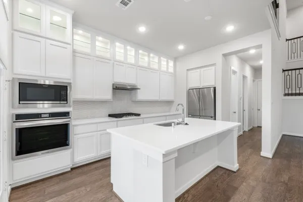 a kitchen with stainless steel appliances a stove sink and microwave