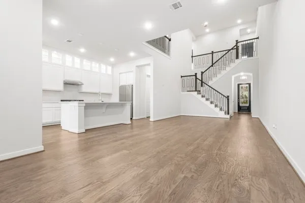a view of a kitchen with furniture and wooden floor