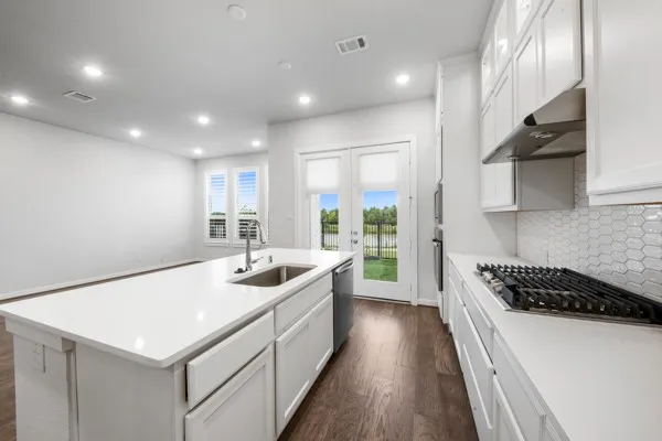 a kitchen that has a sink and a stove