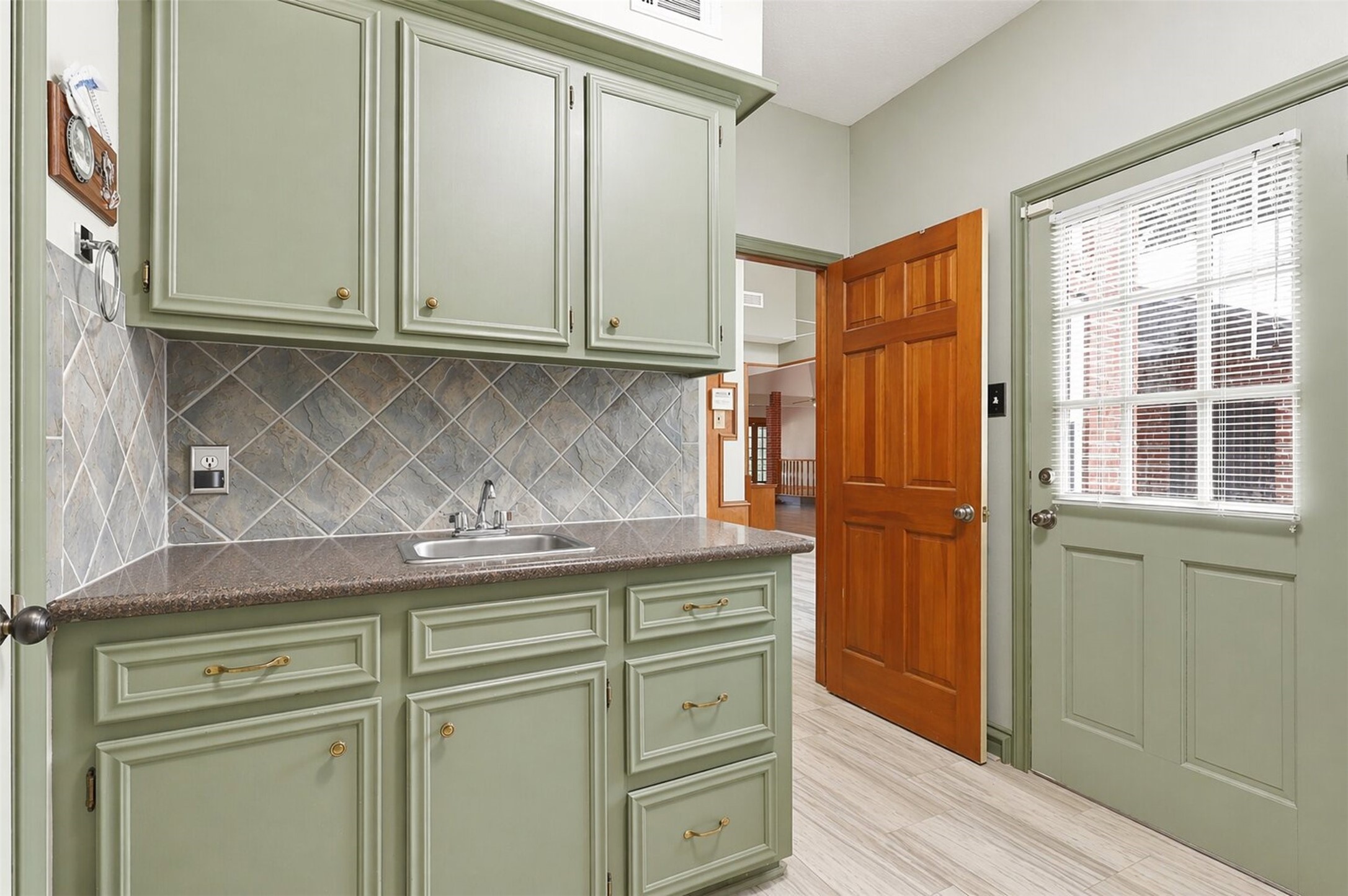 6118 Hampton Way Court Spring, TX 77389 - Photo 13 of 27 Utility Room is in the house near the kitchen which includes another restroom and sink. Plenty of space for storage