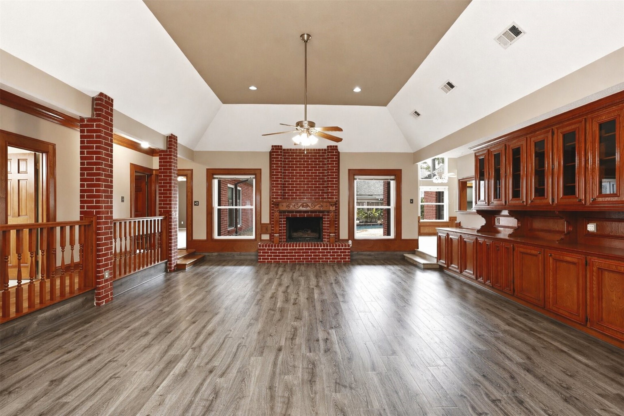 6118 Hampton Way Court Spring, TX 77389 - Photo 2 of 27 Welcome to this spacious Living Room where plenty of storage is available in these original built ins with glass doors. Fire place makes for a cozy environment on a chilly night.