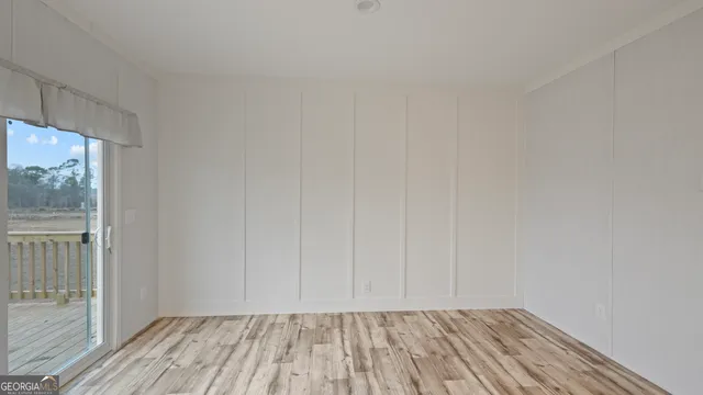 a view of room with window and hardwood floor