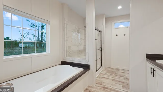 a bathroom with a bathtub and a window